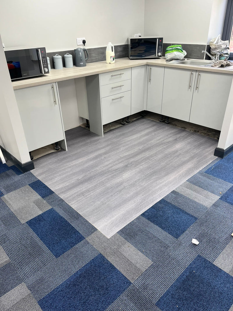 JHS Everyway Carpet Tile - Airforce Blue - fitted in Canteen, with Nerok70 Commercial vinyl - Timber Grey - fitted to Kitchen Apron
