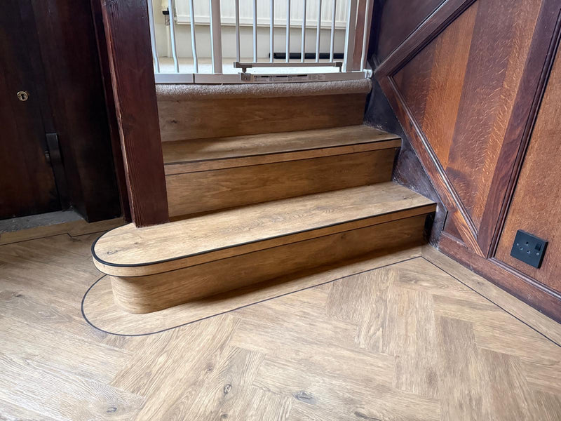 J2 Flooring Natural Timbers Parquet - Carpenters Oak - fitted in Hallway with contrasting design strips, leading on to staircase with StairRods Antique Bendy Bull